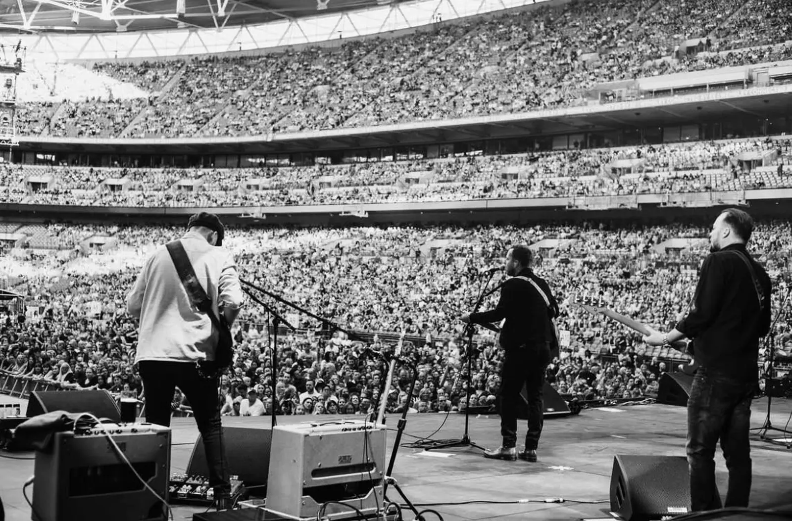 Connor McDonald on stage with the band at Wembley Stadium in front of a packed crowd