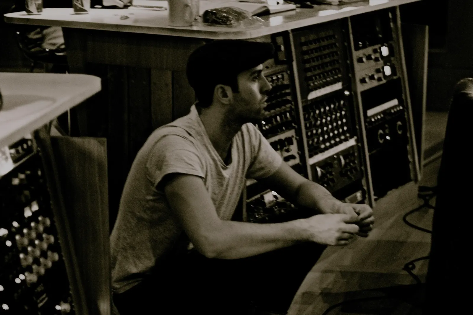 Connor McDonald seated at a vintage recording studio mixing console